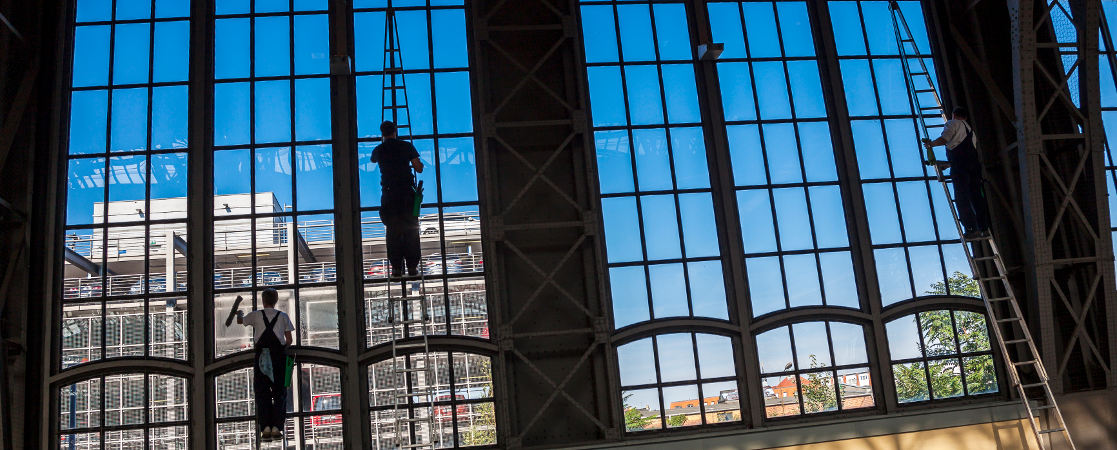 Window cleaner washing storefront glass in Portsmouth