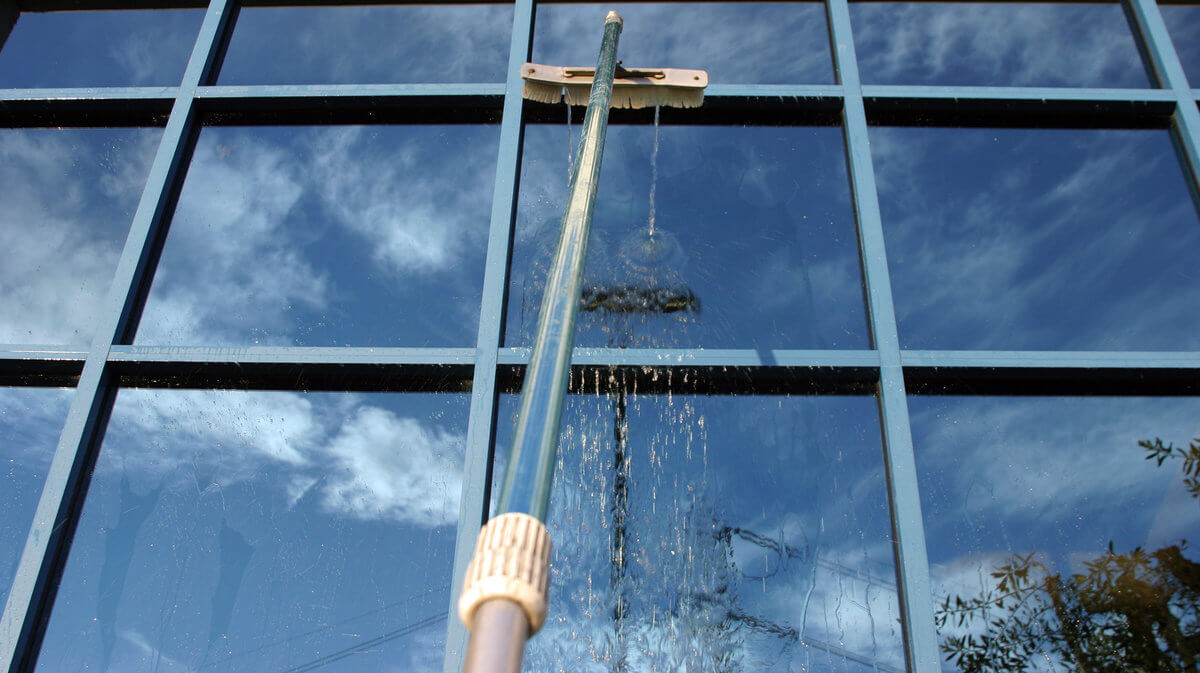 Water fed pole washing office tower glass in Worcester